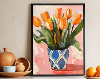May include: A framed painting of a bouquet of orange tulips in a blue and white patterned vase. The vase is sitting on a pink surface.