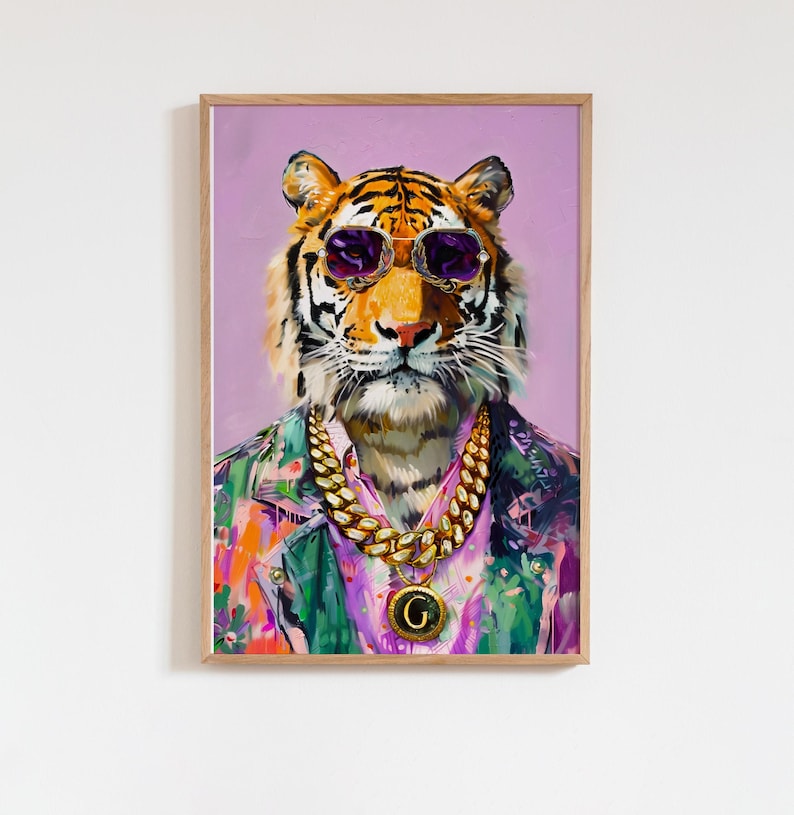 May include: Framed art print of a tiger wearing sunglasses, a gold chain, and a colourful jacket. The tiger's portrait is set against a lavender background, creating a vibrant and stylish piece of wall decor.
