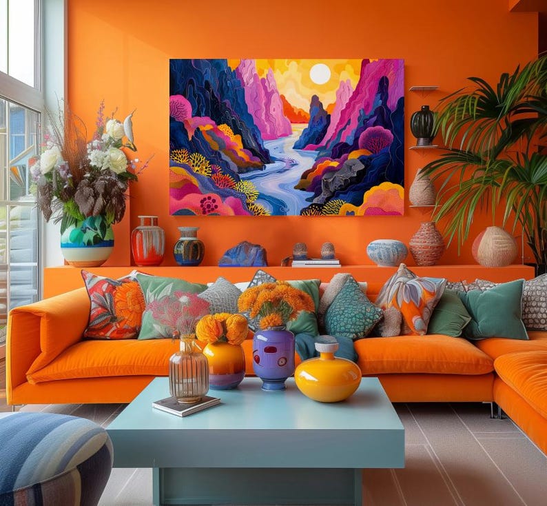 May include: A bright orange living room with a large abstract painting of a canyon with a river running through it. The painting is above a large orange sectional sofa with colorful pillows. There are several vases and plants on the shelves and tables.