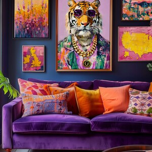 May include: A colourful living room with a purple velvet sofa and cushions in orange, purple, and blue. Above the sofa, framed artwork includes a tiger portrait wearing sunglasses and a gold chain, and abstract paintings.