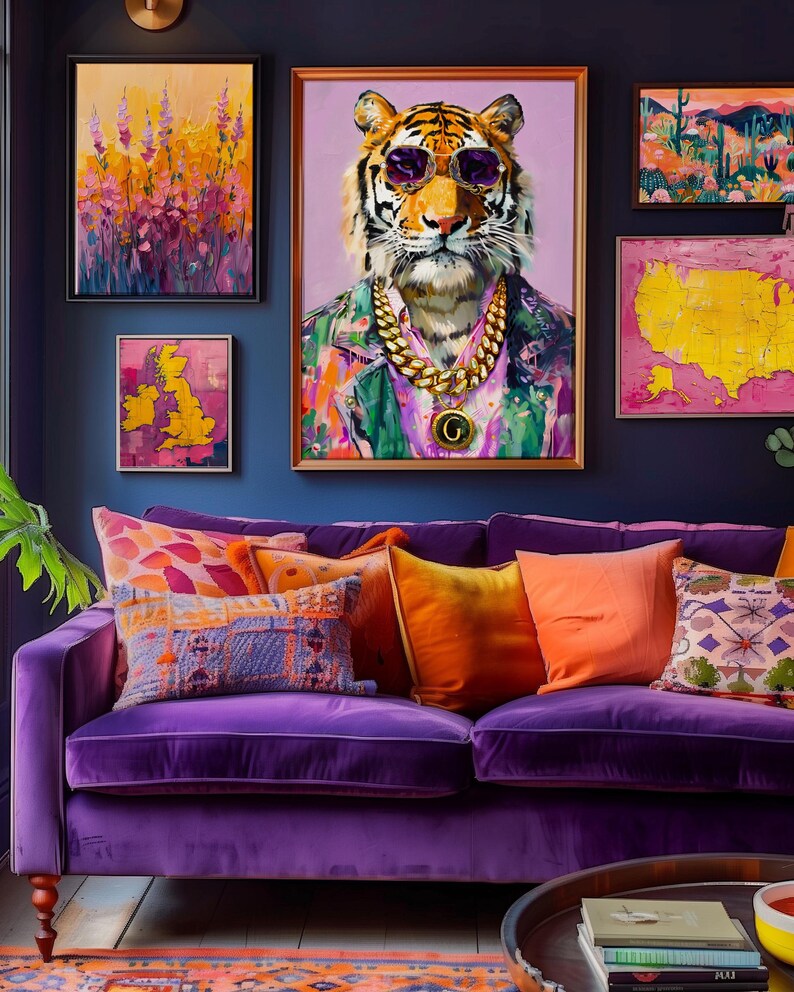 May include: A colourful living room with a purple velvet sofa and cushions in orange, purple, and blue. Above the sofa, framed artwork includes a tiger portrait wearing sunglasses and a gold chain, and abstract paintings.