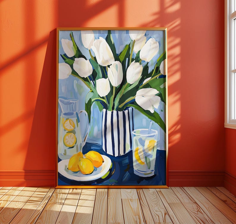 Puede incluir: Una pintura enmarcada representa una naturaleza muerta con tulipanes blancos en un jarr&oacute;n a rayas, una jarra y un vaso de limonada, y limones en un plato. El fondo es azul claro y el marco es dorado.
