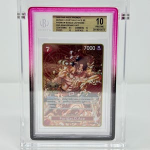 May include: A graded trading card featuring Portgas D. Ace from the One Piece series. The card is encased in a clear plastic holder with a pink border and a Beckett Grading Services label. The card is graded a 10, with text visible.
