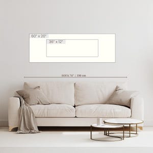 May include: A beige sofa with two cushions and a throw blanket. Two small round coffee tables with marble tops and metal frames are in front of the sofa. The sofa is 74 inches (190 cm) long. The image also shows a rectangular artwork with dimensions of 60" x 20" and 36" x 12".