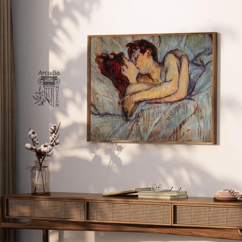 May include: A rectangular wall art print featuring an impressionistic painting of two figures embracing in bed, rendered in soft blue, tan, and reddish-brown tones. The artwork is displayed in a wooden frame and includes the text Arcadia Museum.