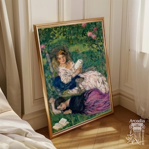 May include: A framed art print featuring an impressionist painting of two figures in a lush green garden. One figure sits in a chair reading a book, while the other lies on the grass nearby. The scene includes pink flowers and a book on the ground.