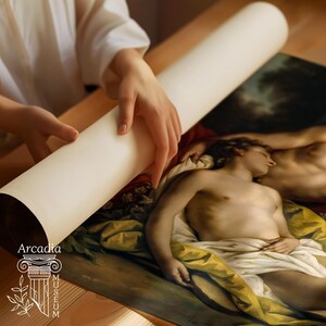 May include: A large, rolled-up art print featuring a classical painting of a reclining figure draped in white and yellow fabric. The print displays the text Arcadia Museum with a column icon in the bottom left corner, printed on white paper.