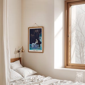 May include: A rectangular framed art print featuring a dark blue night scene with fireworks and two figures resting on a balcony. The print includes the text "Le Feu" at the bottom and is displayed in a thin gold frame with a hanging cord.