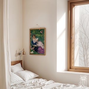 May include: A framed rectangular art print featuring a painting of two figures in a garden, hanging on a plain wall above a bed with white bedding. The artwork depicts a person in a white dress and another in a purple skirt. A brass wall lamp is mounted nearby.