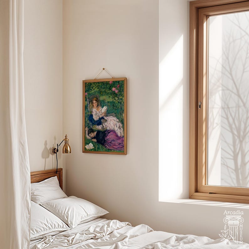 May include: A framed rectangular art print featuring a painting of two figures in a garden, hanging on a plain wall above a bed with white bedding. The artwork depicts a person in a white dress and another in a purple skirt. A brass wall lamp is mounted nearby.