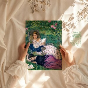 May include: A rectangular art print featuring an impressionist painting of two figures in a garden. One figure sits in a chair reading a book, while another lies on the grass nearby. The scene uses green, pink, and white tones. The text Arcadia is visible.
