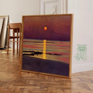 May include: A painting of a sunset over the ocean with a large orange sun in the sky. The water is a deep blue with streaks of pink and orange. The painting is framed in a wooden frame.