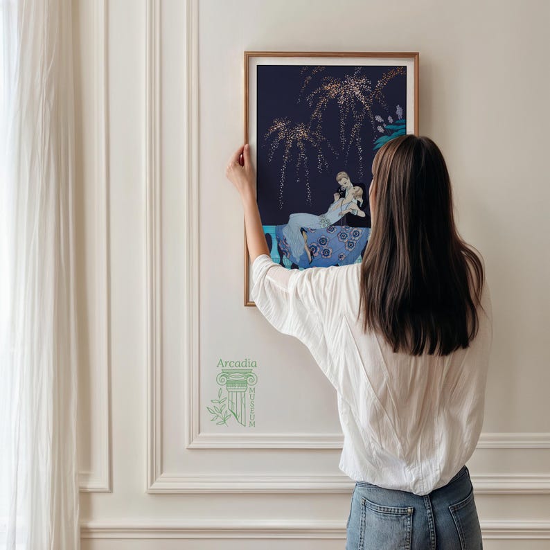 May include: A framed rectangular art print featuring a dark navy background with gold-colored stylized willow branches and a central illustration of a person in a light blue dress reclining on a blue floral patterned chaise lounge chair.