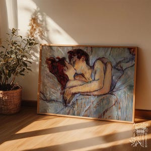May include: A rectangular framed art print featuring an impressionistic painting of two figures embracing and kissing while lying in bed. The artwork uses a palette of soft blues, warm yellows, and deep reddish-brown tones with visible brushstrokes.