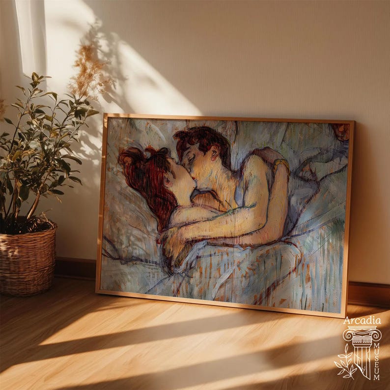 May include: A rectangular framed art print featuring an impressionistic painting of two figures embracing and kissing while lying in bed. The artwork uses a palette of soft blues, warm yellows, and deep reddish-brown tones with visible brushstrokes.