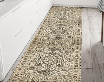 May include: A beige and brown patterned runner rug with a geometric design. The rug is placed in a kitchen with white cabinets and a wood floor.