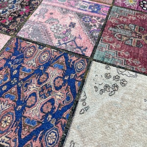 May include: A patchwork rug with a variety of colors and patterns, including pink, blue, red, and green. The rug is made of different pieces of fabric sewn together.