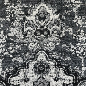 May include: Black and white area rug with a traditional Persian design. The rug has a distressed look and features intricate floral patterns.