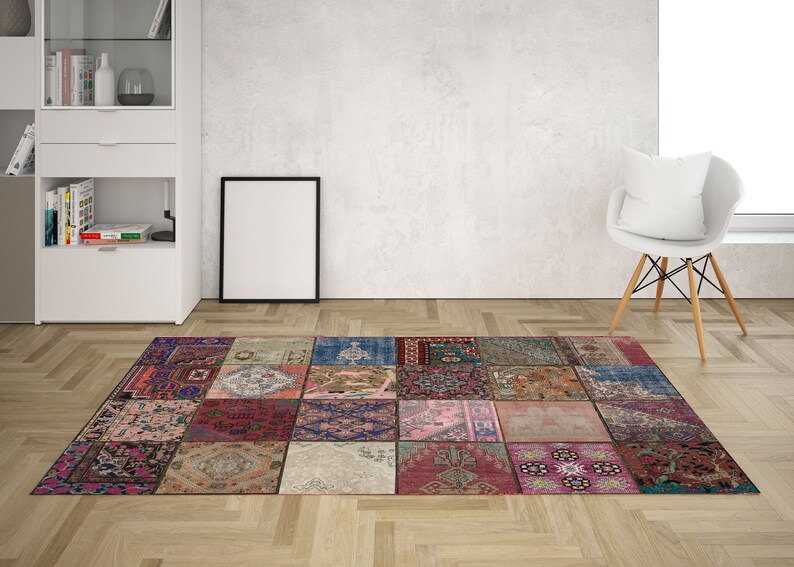 May include: A colorful patchwork rug with a variety of patterns and colors, including red, blue, green, and pink. The rug is made up of individual squares that are sewn together.
