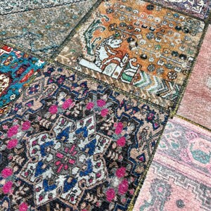 May include: A patchwork rug with a variety of colors and patterns, including pink, blue, green, and brown. The rug is made up of several smaller rugs sewn together.