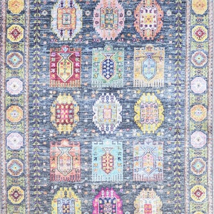 May include: A colorful rug with a geometric pattern in shades of blue, green, yellow, pink, and red. The rug has a border with a floral design.