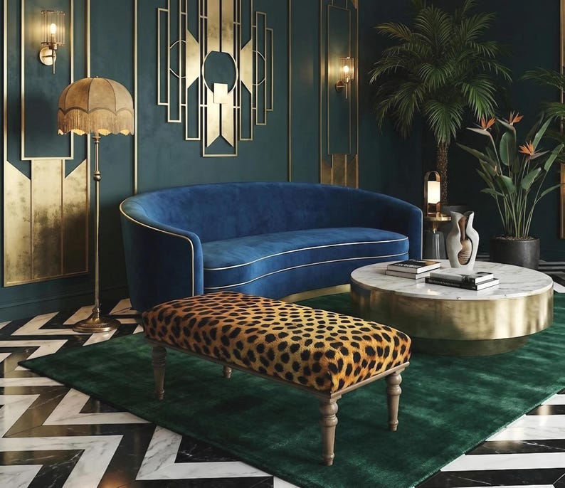 May include: A luxurious living room with a blue velvet sofa, a leopard-print bench, and a marble-topped coffee table. The room features gold accents, a green rug, and a patterned floor. A fringed floor lamp and decorative wall art add to the elegant decor.