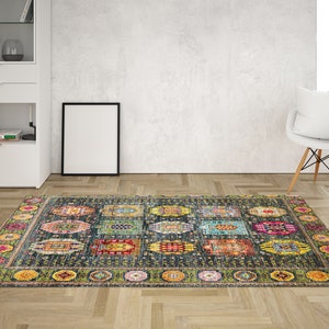 May include: A colorful patterned rug with a dark blue background and a border of green, yellow, and pink. The rug has a geometric design with various shapes and colors.