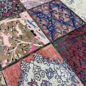 May include: A patchwork rug with a variety of colors and patterns, including pink, blue, brown, and white. The rug is made of different pieces of fabric sewn together.