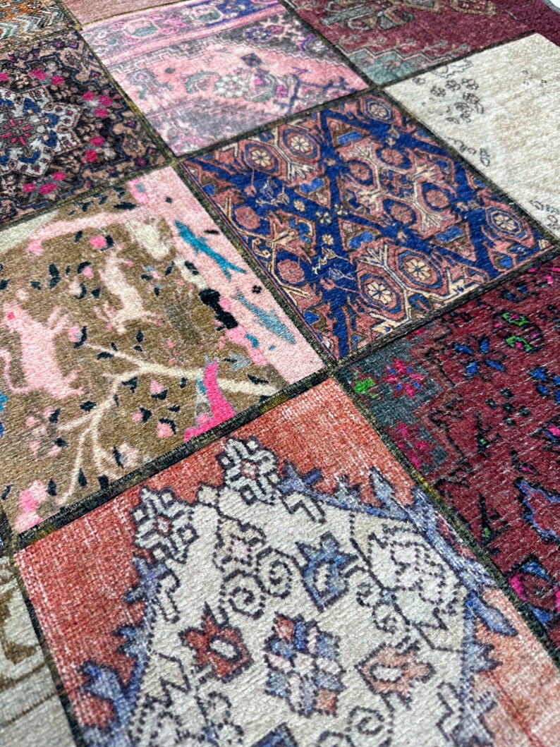 May include: A patchwork rug with a variety of colors and patterns, including pink, blue, brown, and white. The rug is made of different pieces of fabric sewn together.
