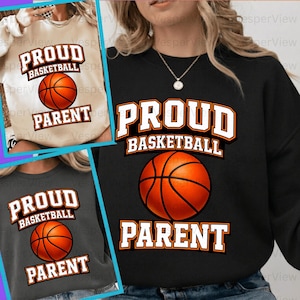 May include: Three sweatshirts featuring the text "PROUD BASKETBALL PARENT" and a basketball graphic. The sweatshirts are in black, grey, and cream. The text is in white and orange.