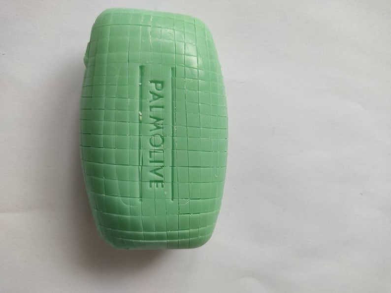 May include: A green bar of soap with the word "PALMOLIVE" embossed on the side.