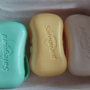 May include: Three bars of Safeguard soap, one green, one yellow, and one white.