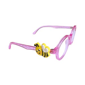 May include: Pink glitter eyeglasses with a cartoon bee accent. The glasses have a round frame and clear lenses. The bee is yellow, black, and white. The arms of the glasses curve down to fit over the ears.