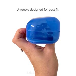 May include: A translucent blue, rounded, rectangular plastic case with a smooth finish. The text "Uniquely designed for best fit" is printed in black above the object. The case features a horizontal seam and a hollow interior structure.