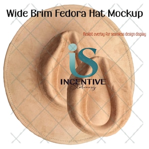 May include: A tan wide brim fedora hat mockup. The hat has a rounded crown and a wide brim. The text "Wide Brim Fedora Hat Mockup" is at the top. The hat is a neutral colour and appears to be made of suede or a similar material.