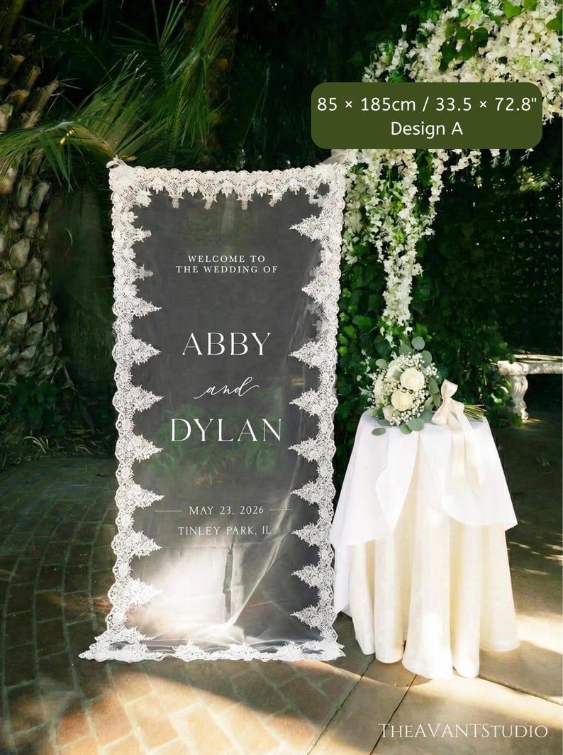 Puede incluir: Un letrero de bienvenida de boda rectangular con un panel de tela blanca transparente y bordes de encaje intrincados. El texto dice: WELCOME TO THE WEDDING OF ABBY and DYLAN MAY 23, 2026 TINLEY PARK, IL. El letrero mide 85 x 185 cm.