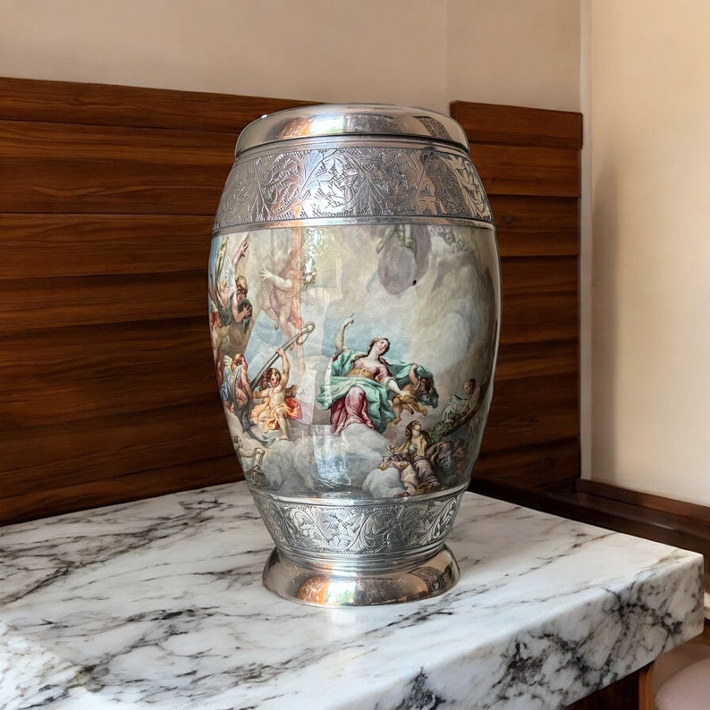 May include: A silver vase with an ornate design and a painted scene of people in the clouds. The vase has a round body and a wide base.
