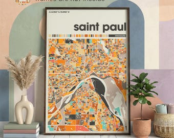 May include: A framed map print of Saint Paul, Minnesota, showing an abstract, colourful representation of the city's layout. The print includes the city name in bold, white text and coordinates. The map is in a wooden frame.