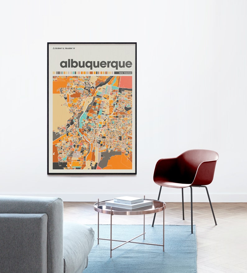 May include: A framed poster with a colorful map of Albuquerque, New Mexico. The poster has a black frame and the city name is printed in brown text at the top.