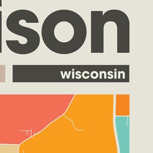 May include: A graphic design featuring the word "ison" in black text with a white background. The word "wisconsin" is written in black text on a gray bar below the word "ison". The bottom of the image shows a stylized map of a city with orange, red, and blue colors.
