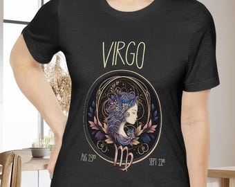 May include: Black t-shirt with a gold and purple illustration of the Virgo zodiac sign. The illustration includes a woman with flowers in her hair and the text "VIRGO" above the illustration. The dates "AUG 23rd" and "SEPT 22nd" are below the illustration.