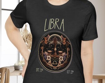 May include: Black t-shirt with a gold and brown Libra zodiac symbol and the text "LIBRA" in a light yellow font. The dates "SEPT 23rd" and "OCT 22nd" are printed in a light yellow font below the symbol.