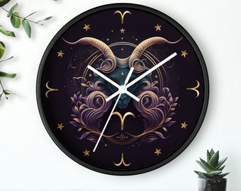 Puede incluir: Un reloj negro con un diseño dorado y morado que presenta el símbolo del zodíaco de Aries. El reloj tiene manecillas blancas y un fondo negro.