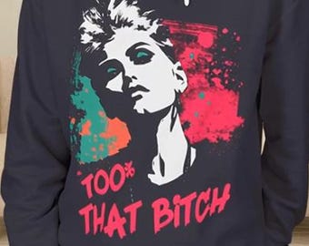 May include: Navy blue long-sleeve sweatshirt featuring a graphic of a woman's face in white, with red and green accents. The text "100% THAT BITCH" is printed in red at the bottom of the design.