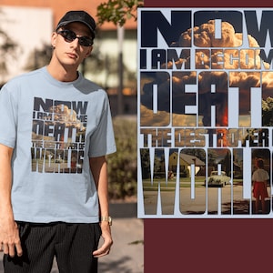 May include: A light blue t-shirt with a graphic print of a mushroom cloud and the text "NOW I AM BECOME DEATH THE DESTROYER OF WORLDS".