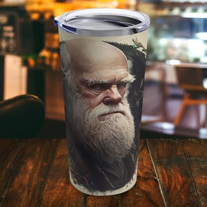 May include: A stainless steel tumbler featuring a white and black image of a man with a long white beard. The man is wearing a dark jacket and has a serious expression on his face.