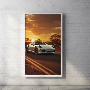 May include: A white sports car drives down a road with a sunset in the background.