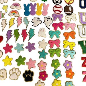May include: A collection of assorted chenille patches featuring various shapes including rainbows, lightning bolts, stars, ghosts, bunnies, sports balls, bows, flowers, paw prints, and letters, all with gold glitter borders for fabric application.