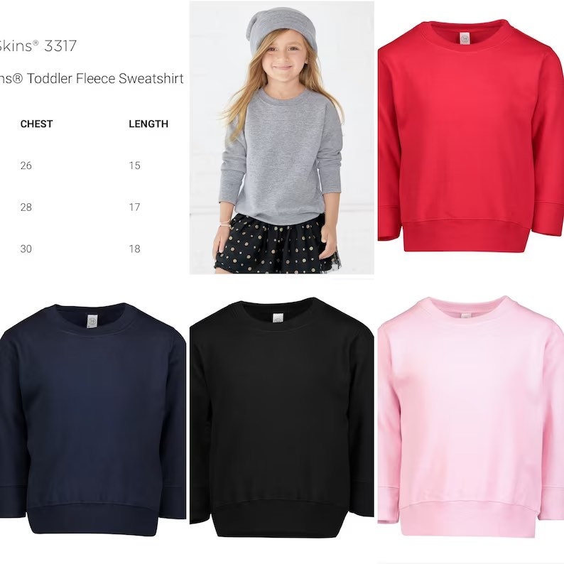 May include: A collection of toddler fleece sweatshirts in red, navy blue, black, and light pink, featuring a crew neckline and long sleeves. A size chart is provided with chest and length measurements in inches for the Rabbit Skins 3317 model.