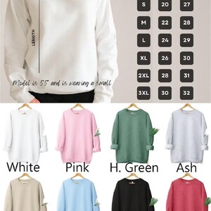 K&ouml;nnte beinhalten: Eine Auswahl an Sweatshirts mit Rundhalsausschnitt in verschiedenen Farben, darunter Wei&szlig;, Rosa und Schwarz. Das Bild enth&auml;lt eine Gr&ouml;&szlig;entabelle mit Ma&szlig;en in Zentimetern und den Text "SWEATSHIRT Size Chart".